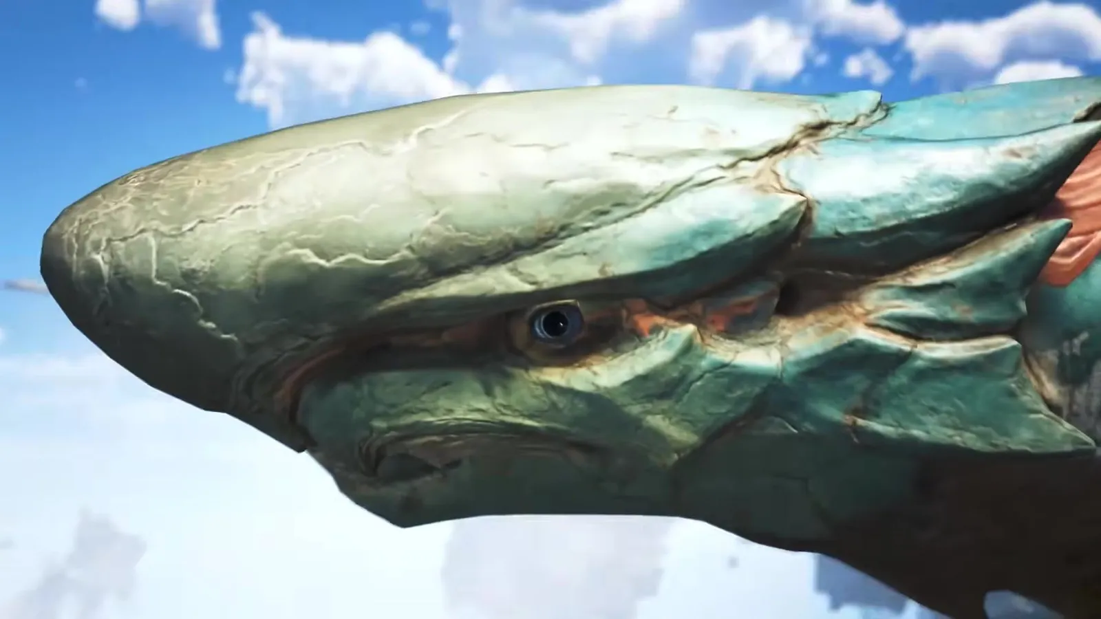 Close-up of Araketa’s teal shark-like head against a blue sky in Monster Hunter Wilds Ascendance