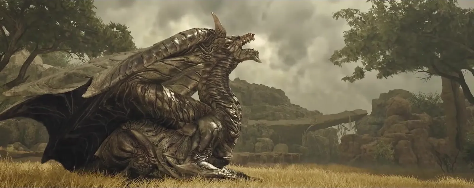Bronze-scaled Kushala Daora crouched on dry grassland among trees under a stormy sky, Monster Hunter Wilds Ascendance trailer