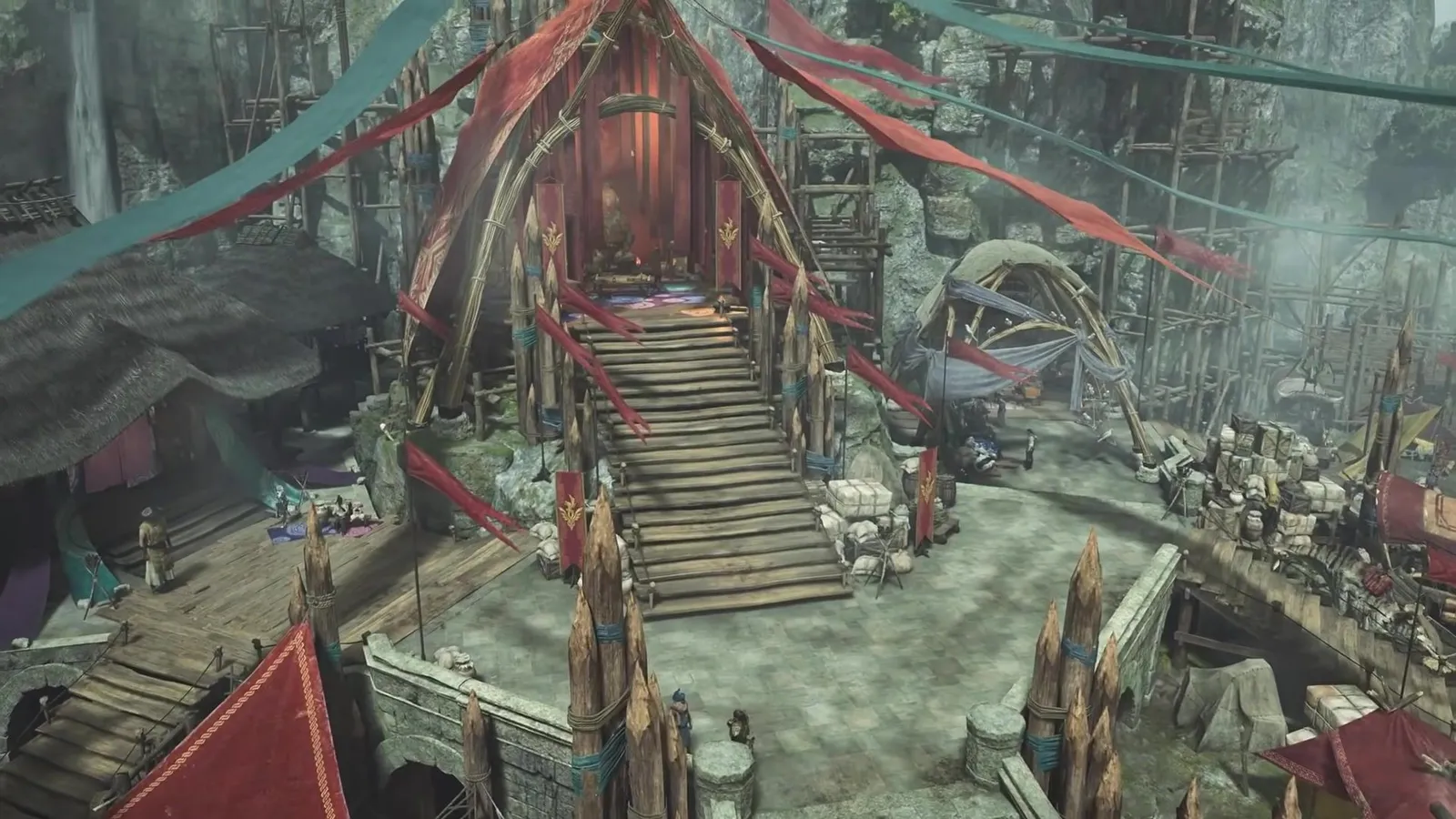 Overhead view of the rebuilt Madoi Stronghold with wooden stairs, red banners and market stalls in Monster Hunter Wilds Ascendance