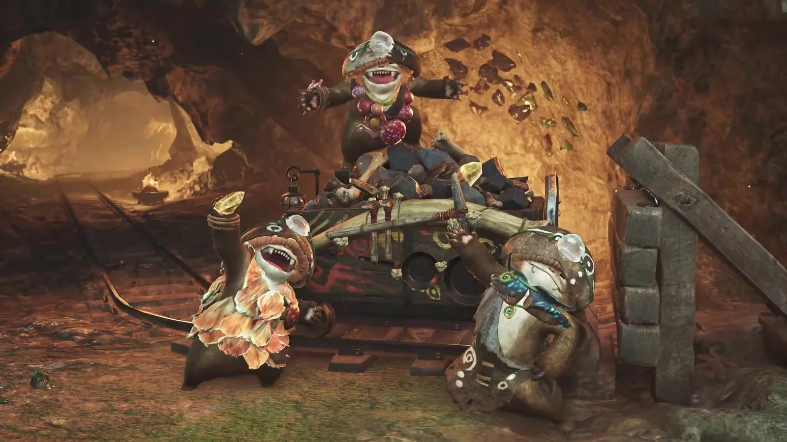 Three Wudwuds at an ore-filled mine cart in a golden tunnel, one holding up a yellow crystal, in the Monster Hunter Wilds Ascendance trailer